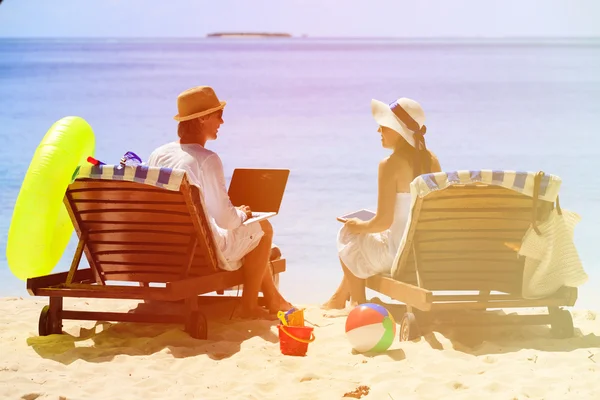 young couple surfing the net and enjoy beach vacation