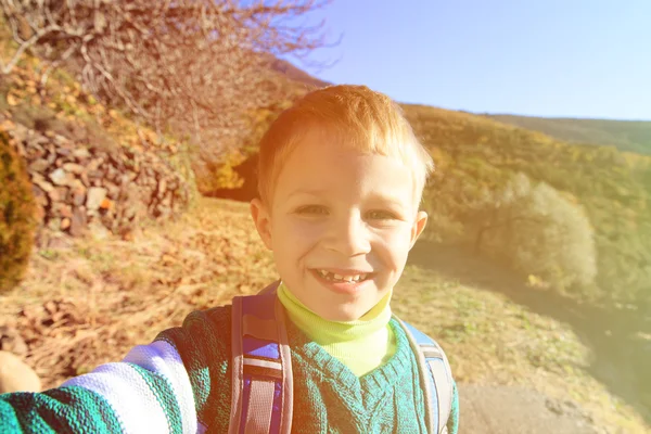 Liten pojke att göra selfie medan resor i höst natur — Stockfoto