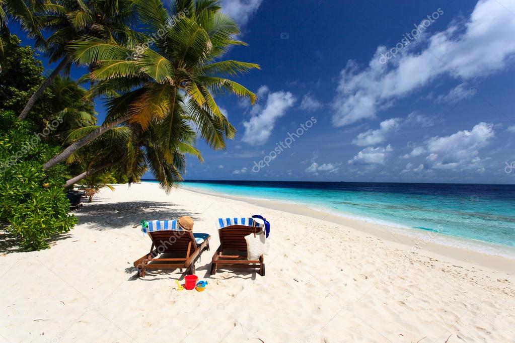 Two chairs on tropical beach, family vacation