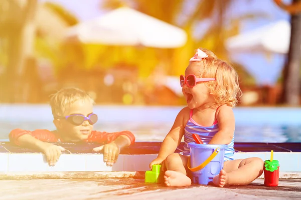 Mały chłopiec i dziewczyna bawi sie w basenie na plaży — Zdjęcie stockowe