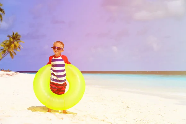 Little boy playing with life ring at beach — Stock Photo, Image