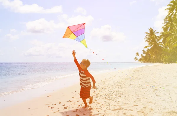 Ragazzino che vola un aquilone sulla spiaggia tropicale — Foto Stock