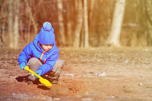 Little boy plaing in spring puddle outdoors — Stock Photo, Image