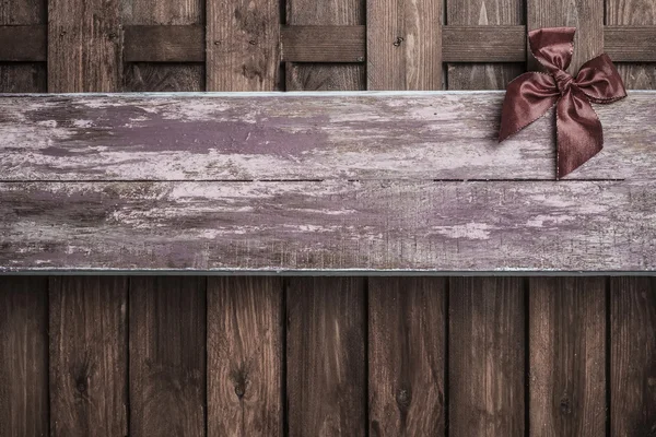 Red bow on wooden background — Stock Photo, Image