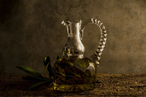 Virgin olive oil in antique elegant jar — Stock Photo, Image