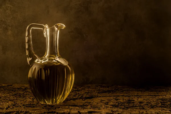 Extra virgin olive oil on old background — Stock Photo, Image