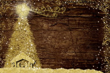 Noel İsa 'nın doğumu sahnesi ve ağaç, dini tebrik kartları. İsa 'nın Doğumu Sahnesi' nin ve Noel ağacının soyut el yazması çizimi. Eski ahşap masa üzerinde altın parıltısı ve kopya alanı..