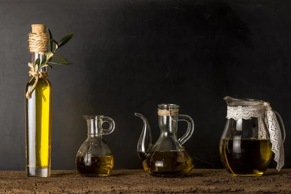 Extra virgin olive oil on rustic background — Stock Photo, Image