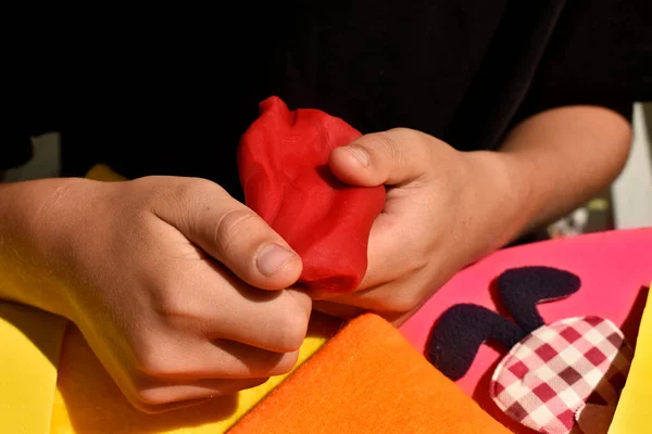 modeling of plasticine, the hands of a child in the process of modeling