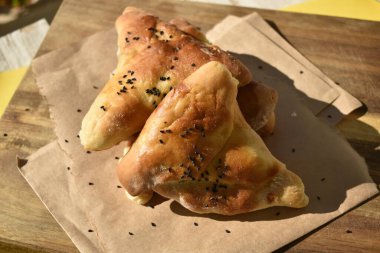 Tahta kesim tahtasında siyah kimyonlu üçlü tatlı hamur tatlısı, Top View