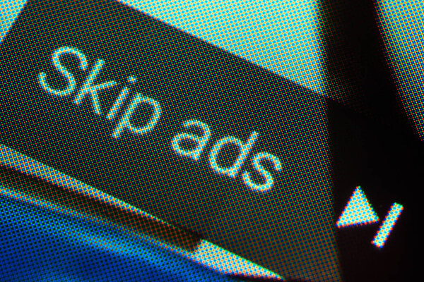 BUENOS AIRES, ARGENTINA - JULY 18, 2019: Macro shot of skip ads button showing up when playing a video on YouTube on mobile phone.