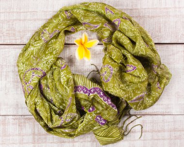 Frangipani çiçek, Bali Adası'nda el yapımı ahşap bir zemin üzerine İpek eşarp düz yatıyordu Üstten Görünüm