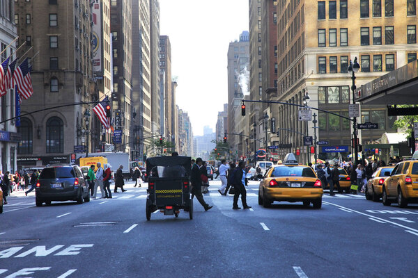 New York, NY, USA - May 15, 2013 : Busy traffic on the street. Intersection along 7th Ave & West 32nd St in midtown Manhattan in New York
