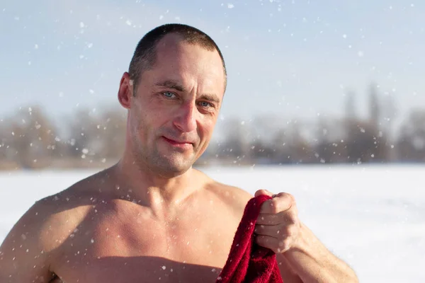 Portrait of a man in winter after swimming in an ice hole.