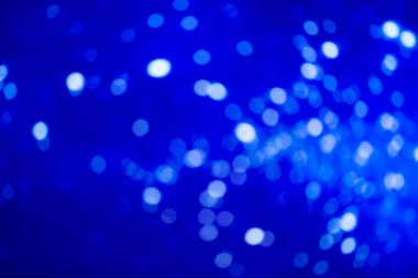 Mavi bulanık arkaplan ve beyaz bokeh lekeleri. Neşeli arkaplan.