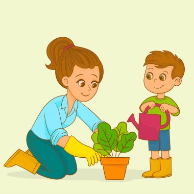 Annesi ve çocuğu organik sebze topluyor. 