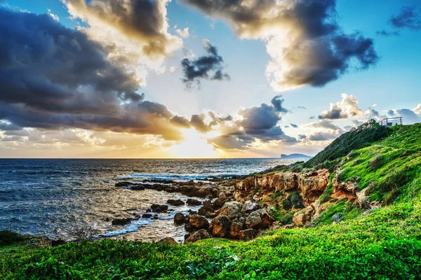 Sun rays and dark clouds over the sea — Stock Photo, Image