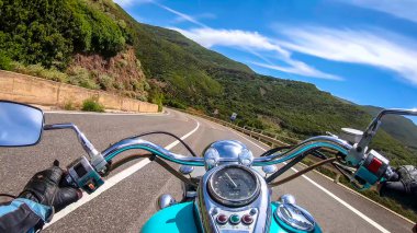 Classic motorcycle ride on a winding road in Sardinia, Italy