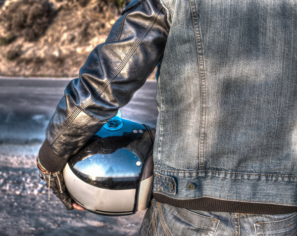 back view of a biker on the edge of the road at sunset in hdr