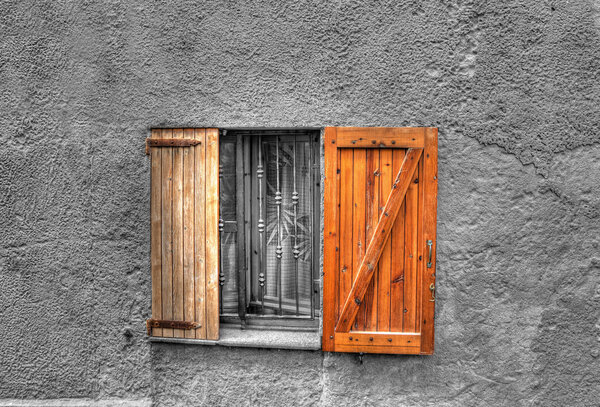 Wooden window in a rustic wall. Processed for selective desaturation effect.