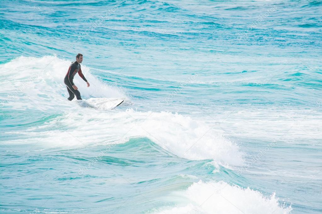 surfing on white and blue waves
