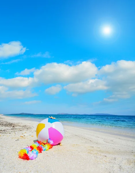 Beach ball with hawaiian necklace — Stock Photo, Image