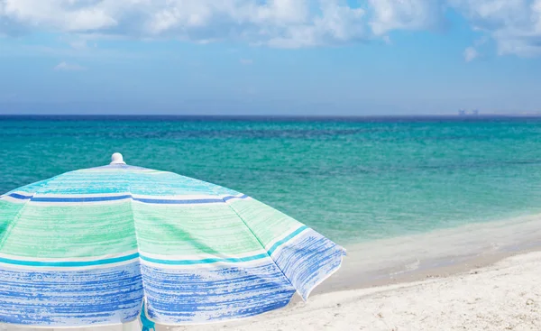 Beach umbrella under a blue sky — Stock Photo, Image