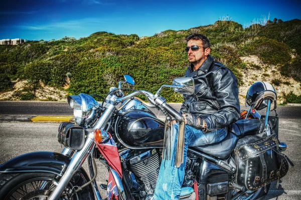 man on a classic motorcycle in hdr