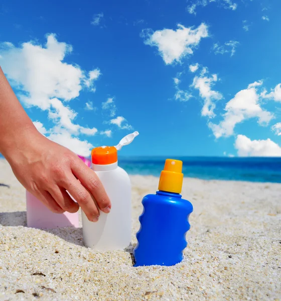 girl holding a suntan bottle