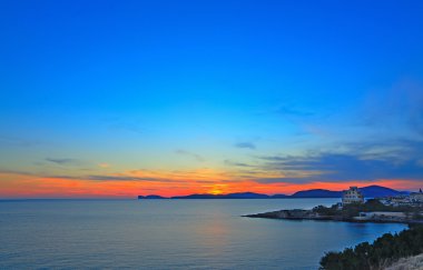 colorful sunset over Alghero shore clipart