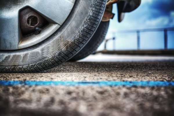 Car wheel on the ground — Stock Photo, Image