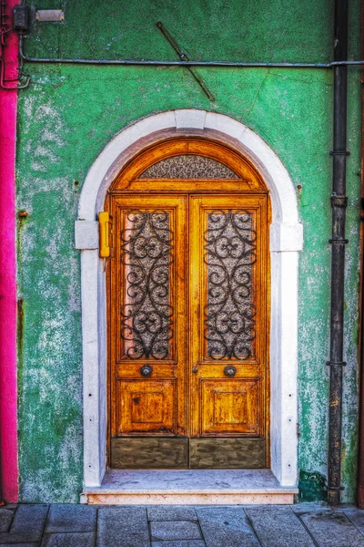 Puerta de madera en una pared rústica verde en Burano —  Fotos de Stock