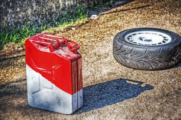 Fuel tank and car wheel on the ground — Stock Photo, Image