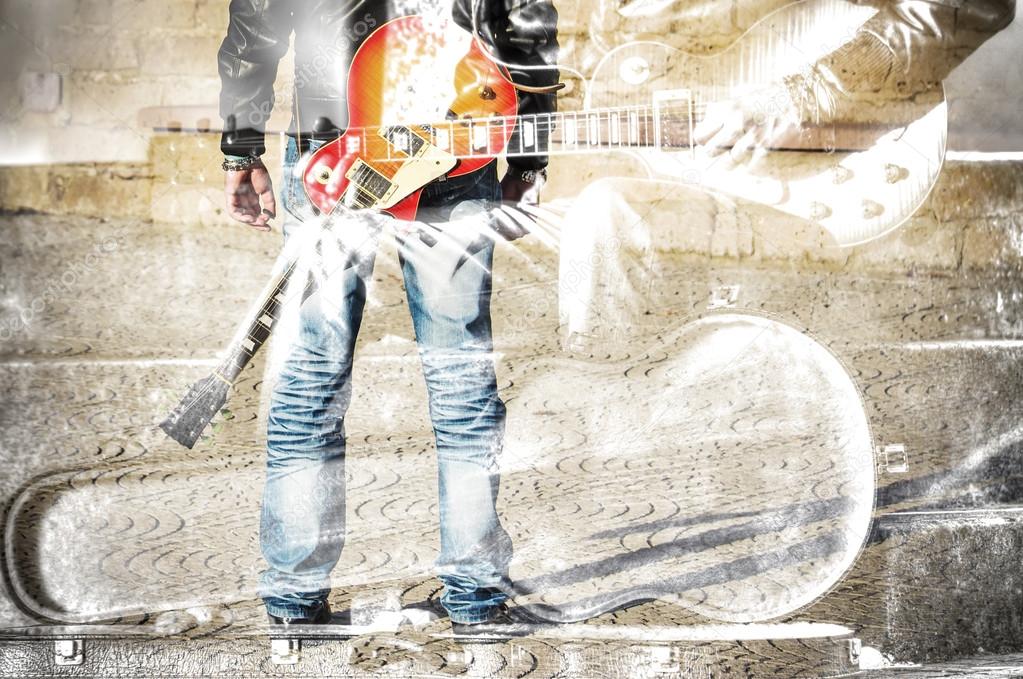 double exposure of a guitarist standing with a guitar