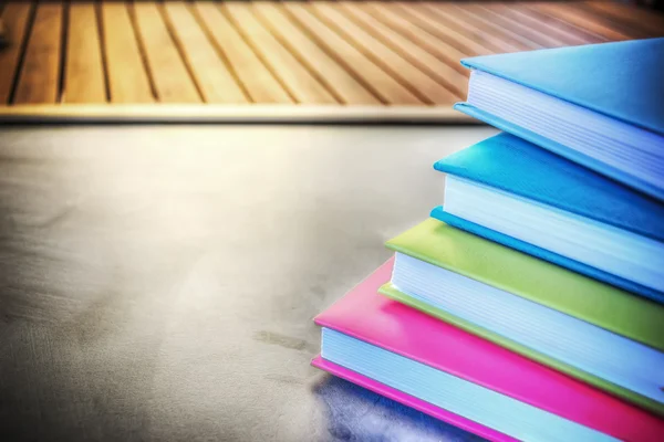 Colorful diaries on a blackboard — Stock Photo, Image