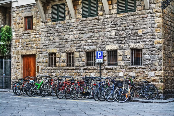 Cykelparkering på en lille plads i Firenze - Stock-foto