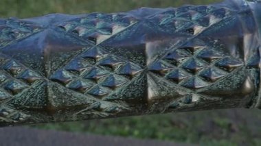 antique bronze cannon with green patina, a close-up 