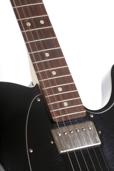 Black electric guitar diagonally on a white background