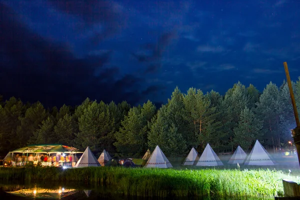 Festa noturna sob a tenda no lago — Fotografia de Stock