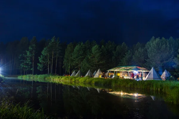 Night party under the tent on the lake — Stock Photo, Image