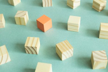 Tahta bloklar grubu ve yeşil arka planda farklı bir renk bloğu. Farklı görüş, yön, fikir, yenilik kavramı