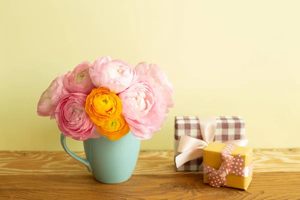 Gift Boxes Vase Ranunculus Flowers Wooden Table Yellow Background — Stock Photo, Image