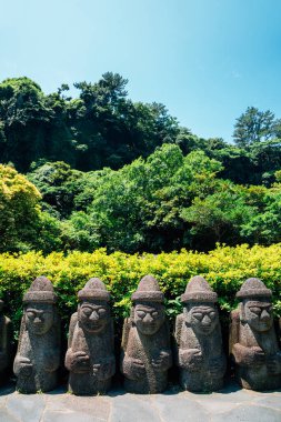 Dol hareubang taşı büyükbaba heykeli Jeju Adası, Kore 'deki Cheonjiyeon Şelalesinde.