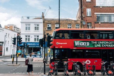 Londra, İngiltere - 6 Haziran 2025: Londra eski şehir sokağı ve kırmızı çift katlı otobüs