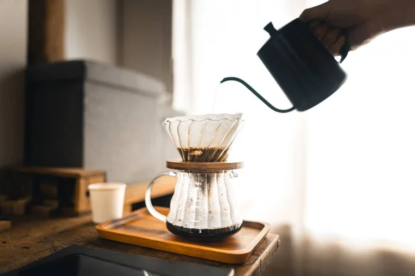 Drip coffee, barista pouring water on coffee ground with filter,brewing coffee