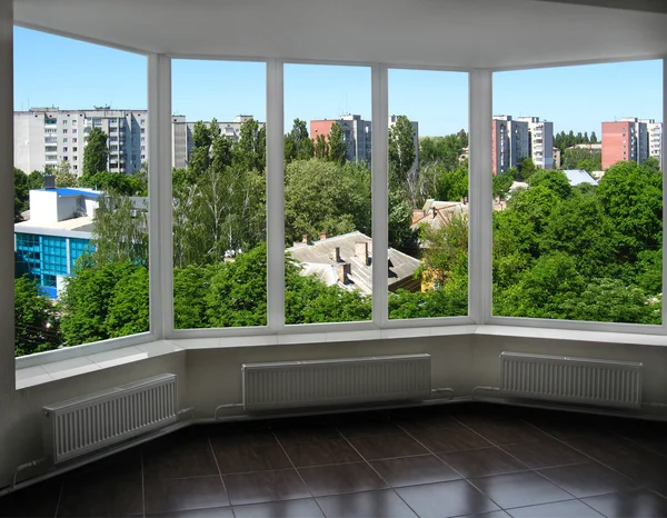 Opened window to the roofs of boisterous city — Stock Photo, Image