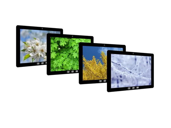 Vier tablet computers met beelden van de seizoenen — Stockfoto
