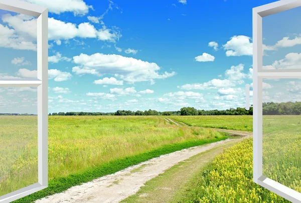 View to clouds meadow and country road from window — Stock Photo, Image