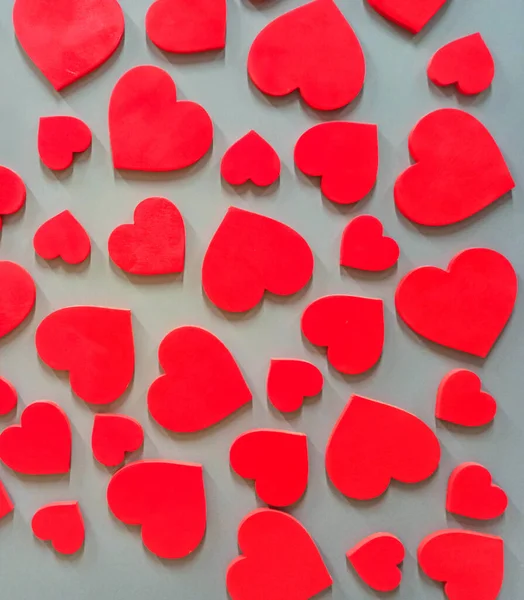 Duvarda asılı kırmızı kalpler. Aşkın dokulu sembolü. Duvarda kırmızı kalpler var. Sevgililer Günü hediyesi. Duvarda şekilli kalpler asılı. iç tasarım