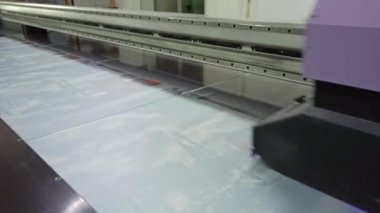 Ultra menekşe yazıcı çalışıyor. Fotoğraflar basılıyor. Modern teknoloji iş başında. Mor ötesi baskılardan oluşan Japon yazıcı Mimaki. Ultraviyole baskı kullanarak cam yüzeyde çizim
